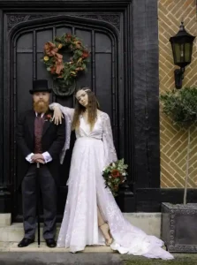 Newlyweds Michael & Wendy pose for a photograph outside their country house hotel wedding venue by Devon Photographer - Robb Webb