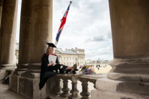 A picture of a university graduate, with her graduation certificate and flowers, taken by and for a very proud father. Graduation Ceremony. Devon Photographer - Robb Webb