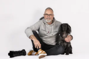 North Devon Family Portrait & Pet Photographer sitting in studio with camera & dog